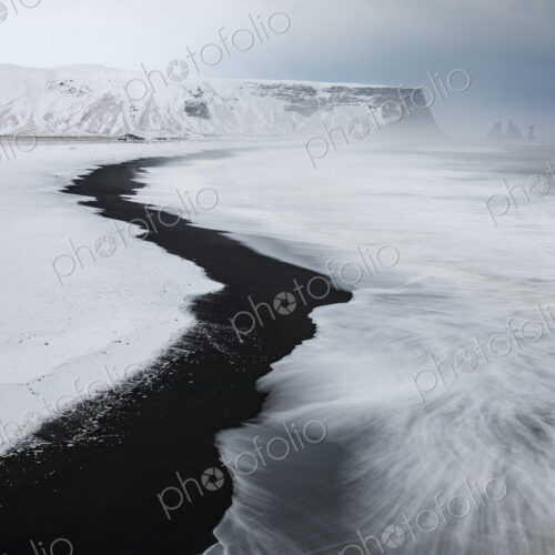 View of Reynisfjara Beach Looking towards Vik, a black sand beach, snow on the sand… View of Reynisfjara Beach Looking towards Vik, a black sand beach, snow on the sand…