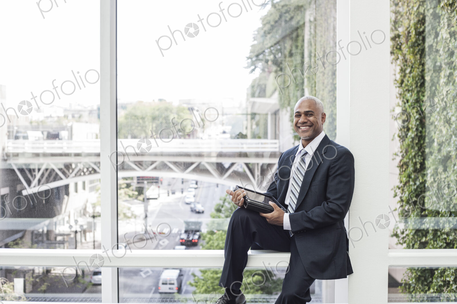 View of a black business man in a dress shirt, tie and suit coat
