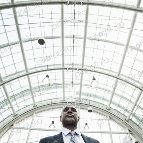 View of a black business man in a dress shirt, tie and suit coat