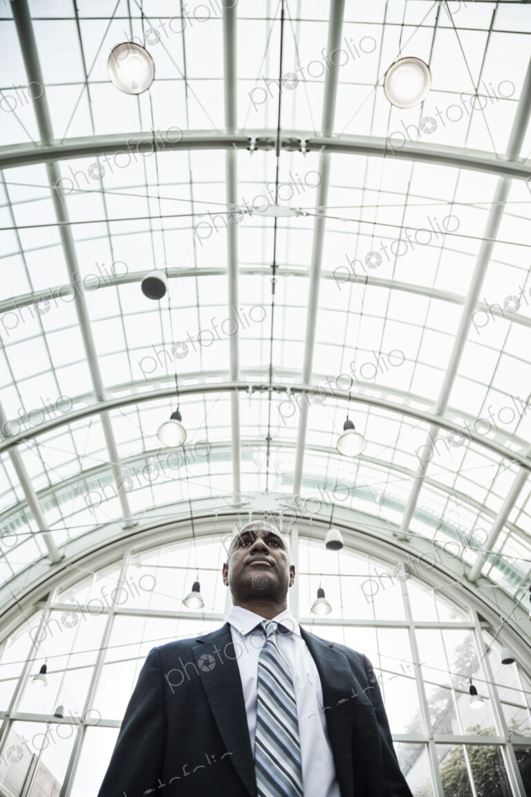 View of a black business man in a dress shirt, tie and suit coat