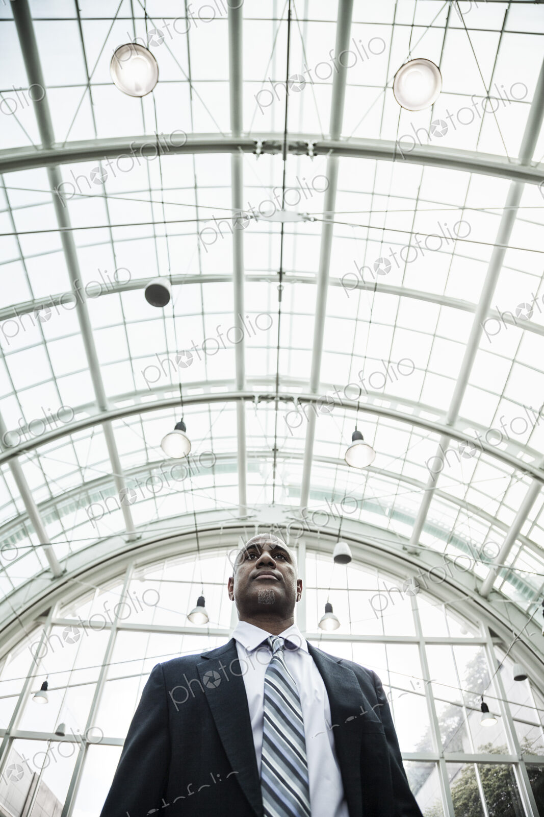View of a black business man in a dress shirt, tie and suit coat
