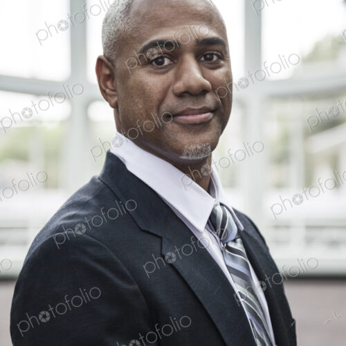 View of a black business man in a dress shirt, tie and suit coat