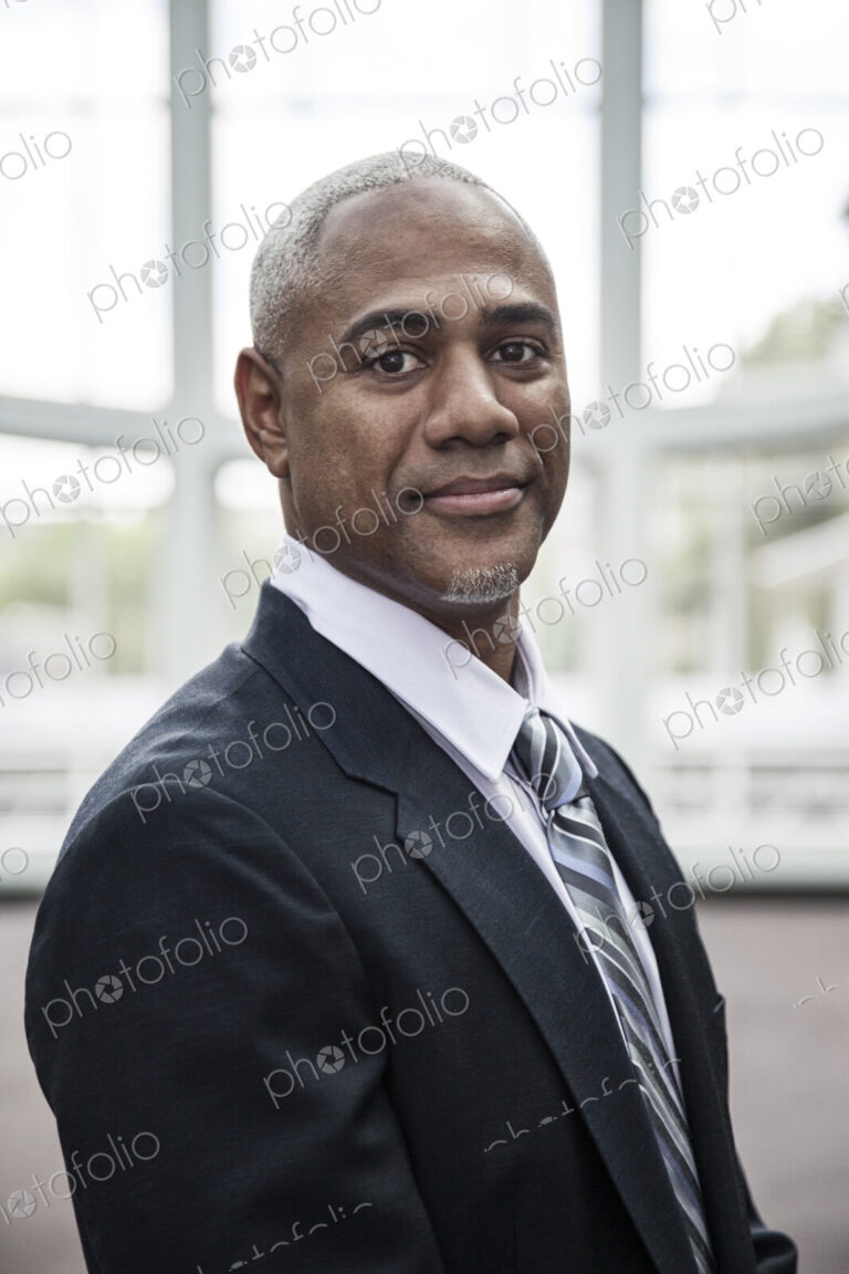 View of a black business man in a dress shirt, tie and suit coat