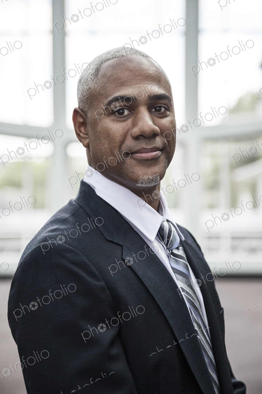 View of a black business man in a dress shirt, tie and suit coat