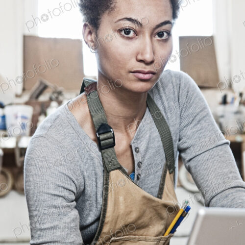 View of a black woman factory worker in a woodworking factory View of a black woman factory worker in a woodworking factory