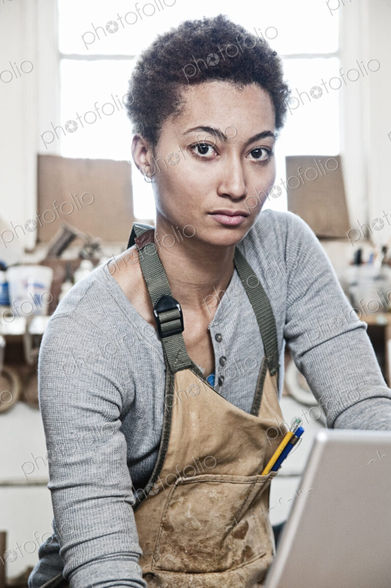 View of a black woman factory worker in a woodworking factory