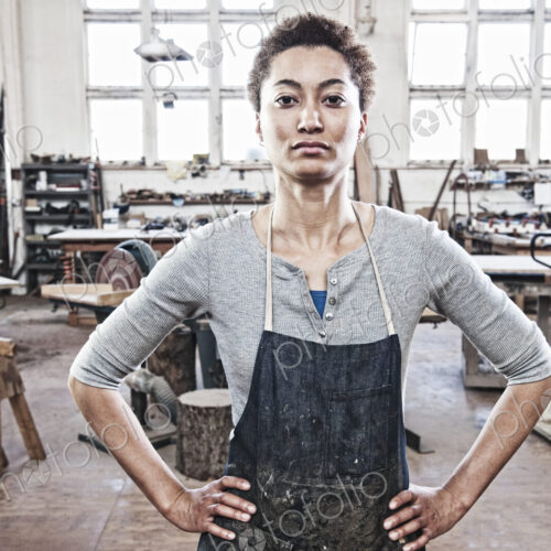View of a black woman factory worker in a woodworking factory