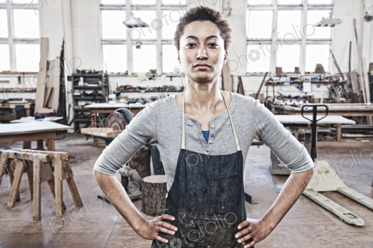View of a black woman factory worker in a woodworking factory