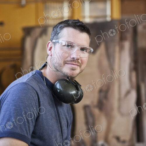View of a caucasian man factory worker in a woodworking factory.