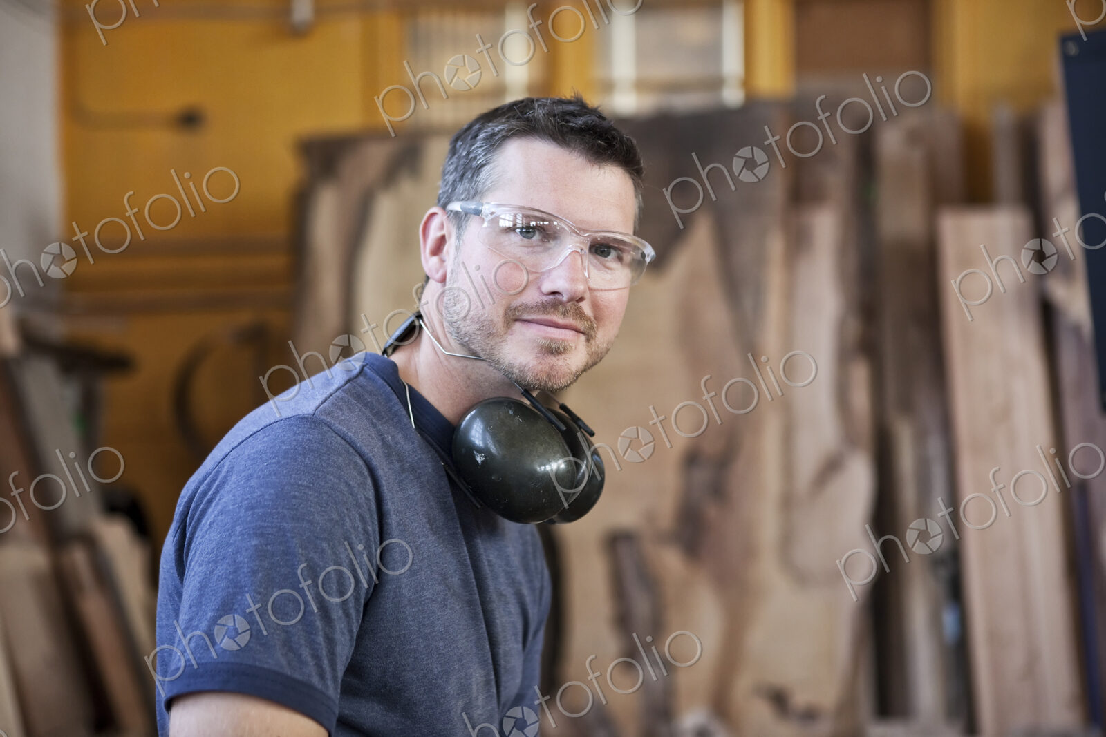 View of a caucasian man factory worker in a woodworking factory.