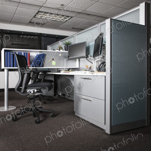 View of an empty cubicle office space at night.