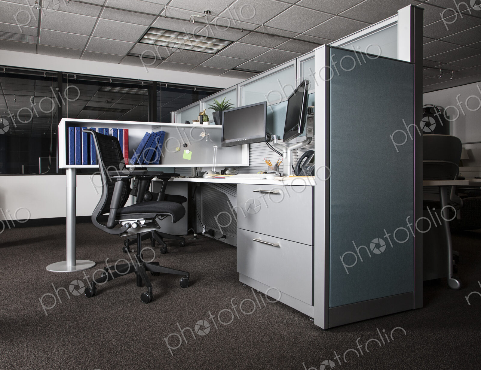 View of an empty cubicle office space at night.