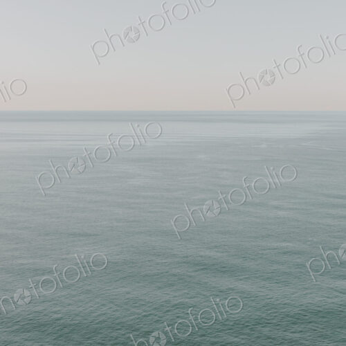 View of calm ocean waters, horizon and sky at dawn, northern Oregon coast View of calm ocean waters, horizon and sky at dawn, northern Oregon coast