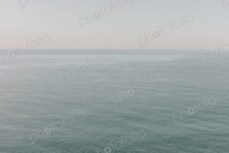 View of calm ocean waters, horizon and sky at dawn, northern Oregon coast