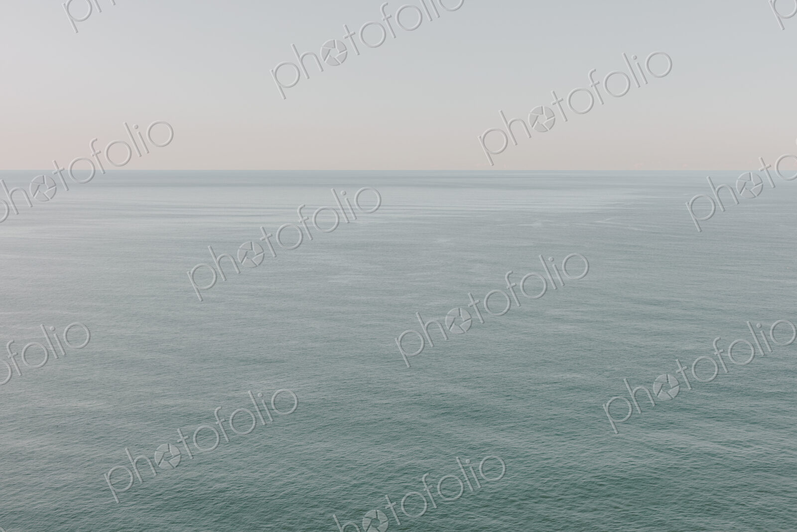 View of calm ocean waters, horizon and sky at dawn, northern Oregon coast