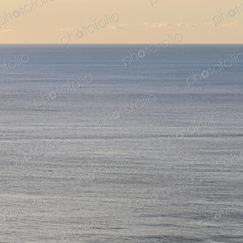 View of calm ocean waters, horizon and sky at dawn, northern Oregon coast
