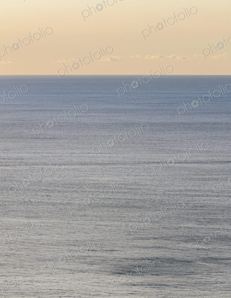 View of calm ocean waters, horizon and sky at dawn, northern Oregon coast