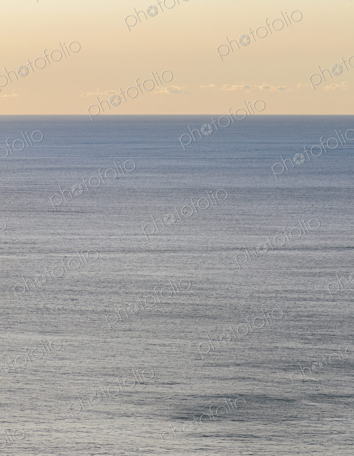 View of calm ocean waters, horizon and sky at dawn, northern Oregon coast