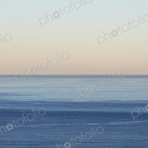 View of calm ocean waters, horizon and sky at dawn, northern Oregon coast
