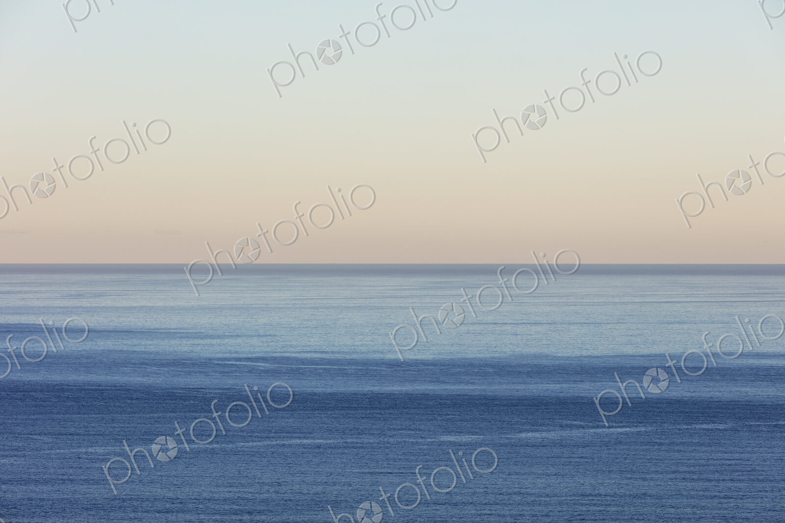 View of calm ocean waters, horizon and sky at dawn, northern Oregon coast
