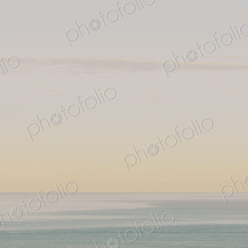 View of calm ocean waters, horizon and sky at dawn, northern Oregon coast