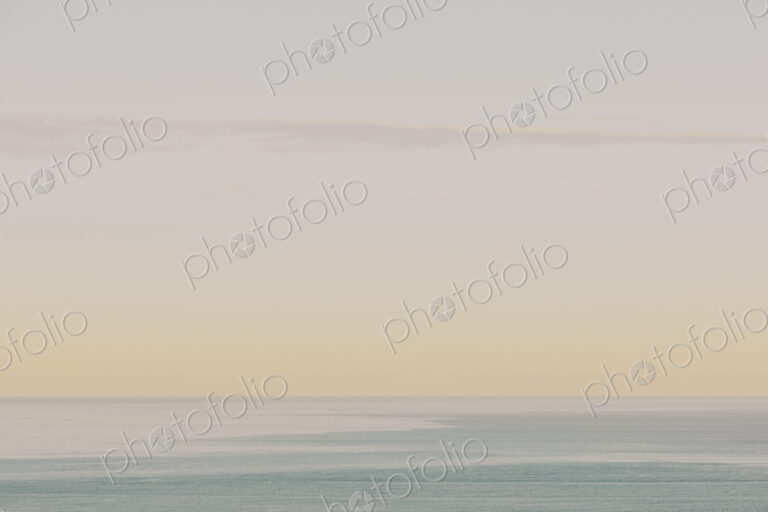 View of calm ocean waters, horizon and sky at dawn, northern Oregon coast