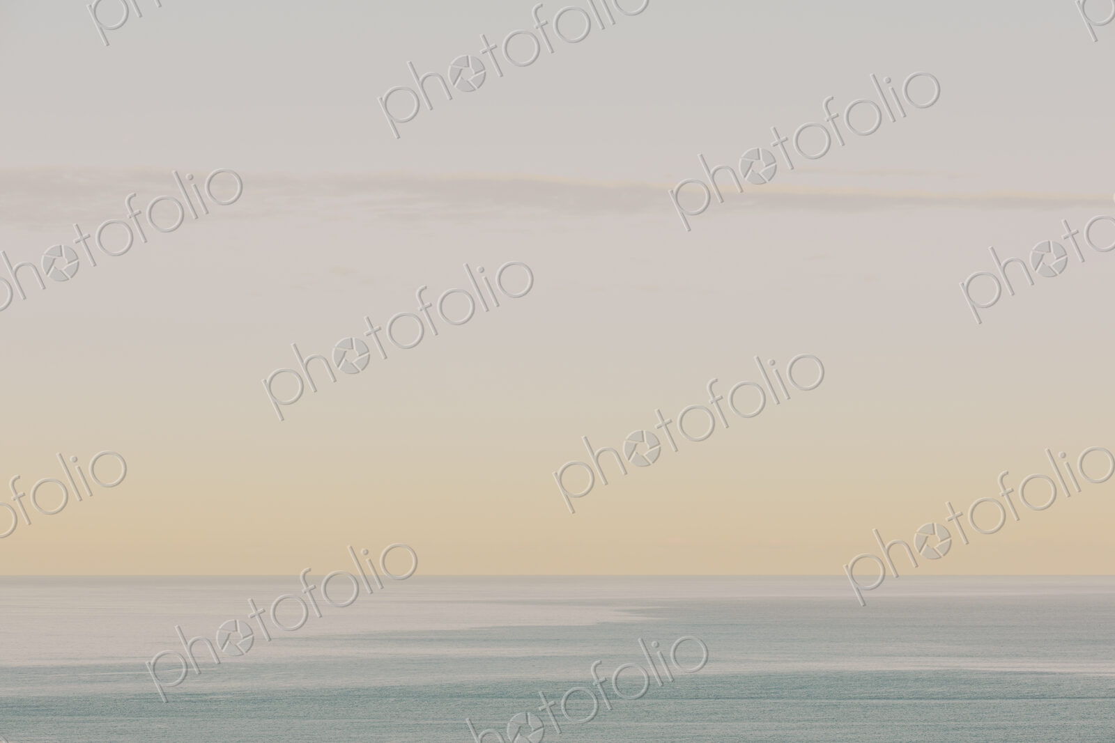 View of calm ocean waters, horizon and sky at dawn, northern Oregon coast