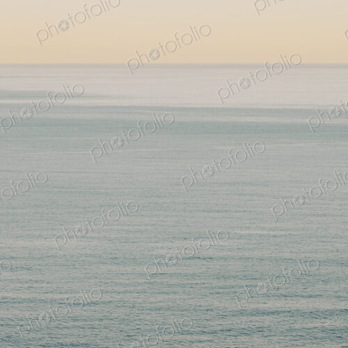 View of calm ocean waters, horizon and sky at dawn, northern Oregon coast
