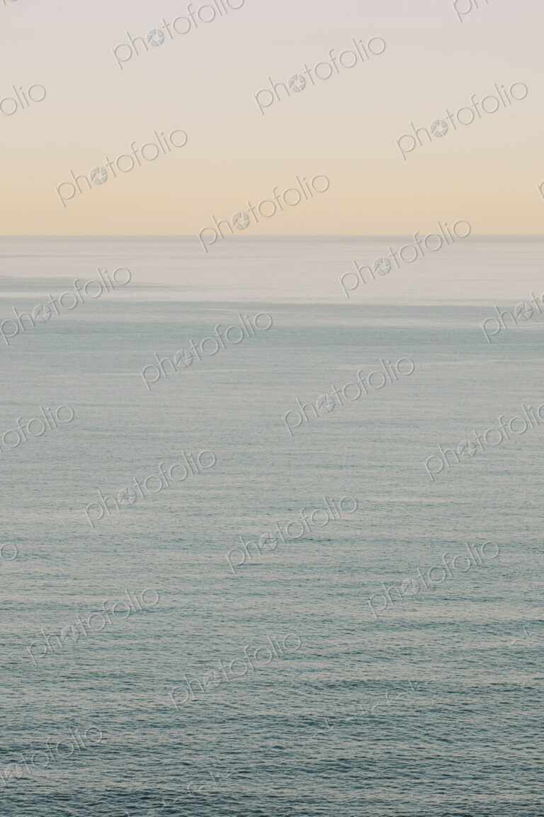 View of calm ocean waters, horizon and sky at dawn, northern Oregon coast
