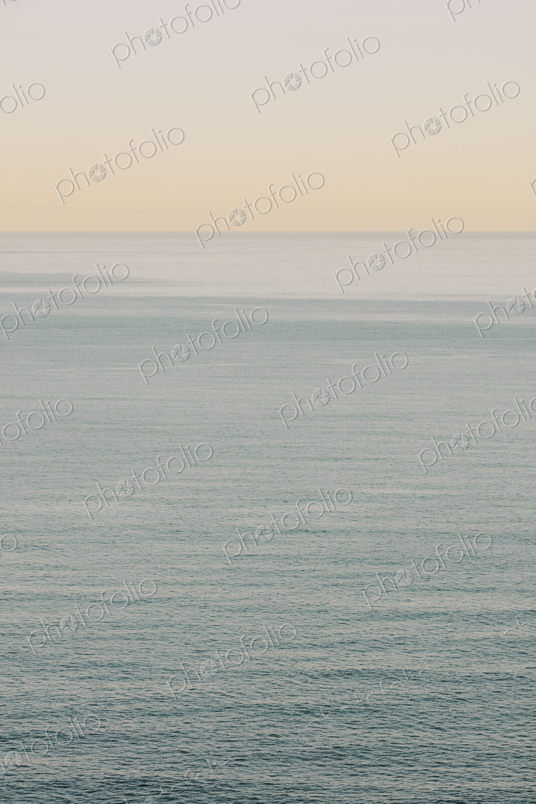 View of calm ocean waters, horizon and sky at dawn, northern Oregon coast