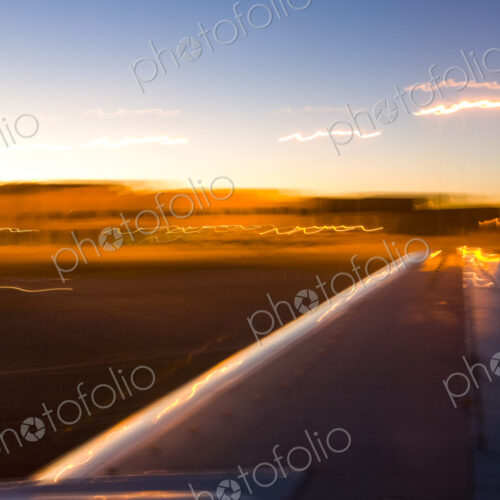 View of plane wing while landing at sunset in Nevada. View of plane wing while landing at sunset in Nevada.