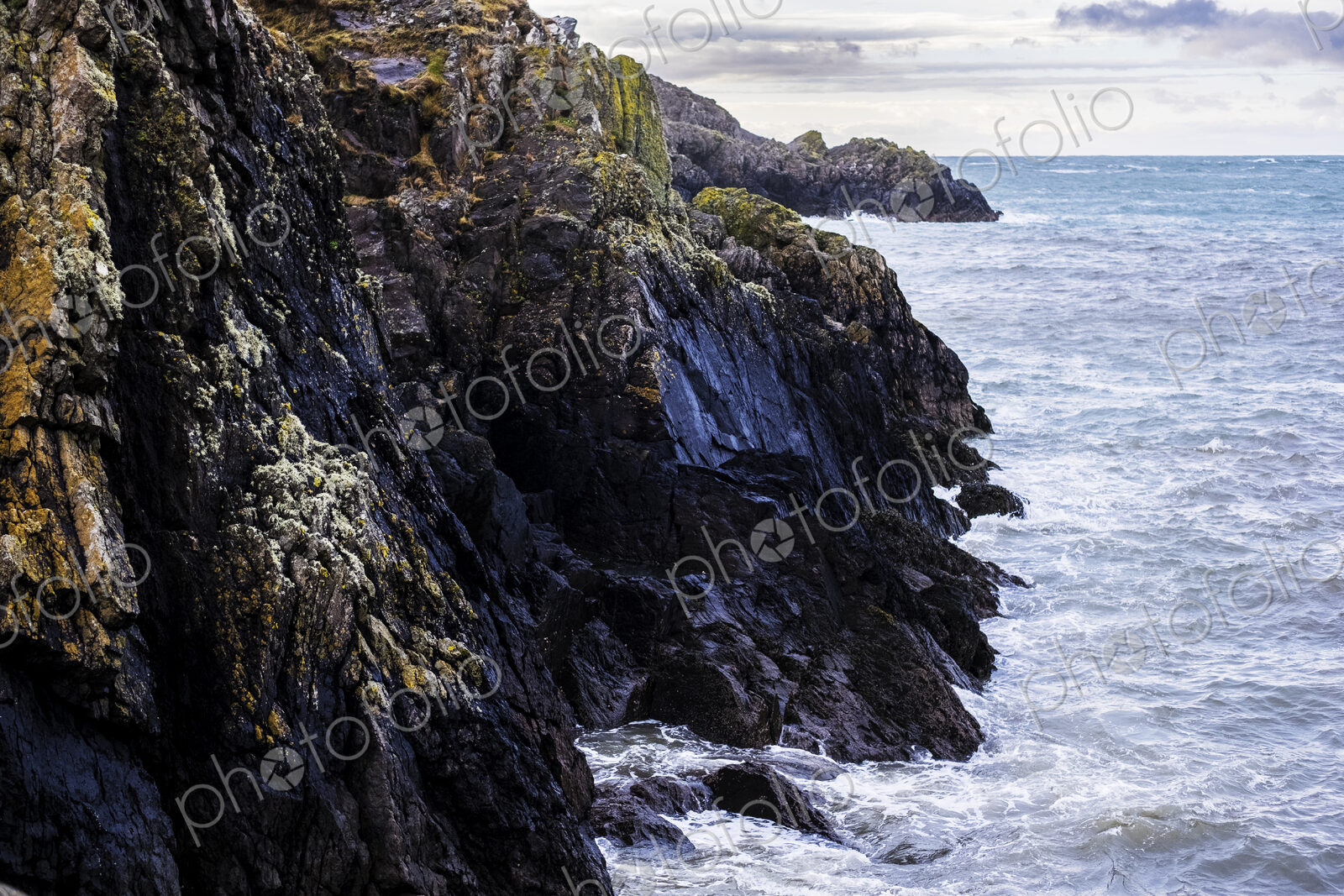 View of rugged cliffs along the coastline of Pembrokeshire National Park, Wales, UK.