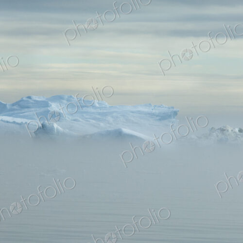 View over the iceberg and land mass off Baffin Bay in Greenland. View over the iceberg and land mass off Baffin Bay in Greenland.
