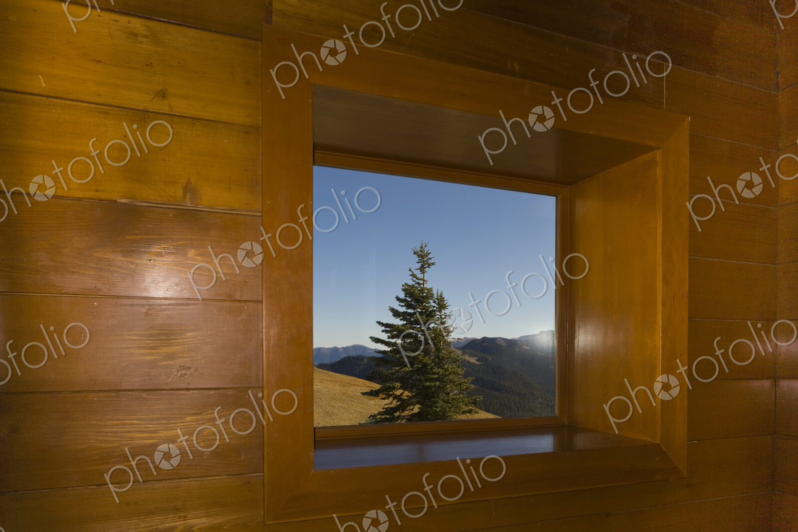 View through a cabin window from Hurricane Ridge to the Olympic Mountains and Olympic…