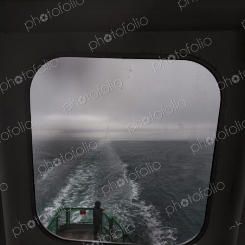 View through a ferry porthole window of the grey stormy weather in the San Juan… View through a ferry porthole window of the grey stormy weather in the San Juan…