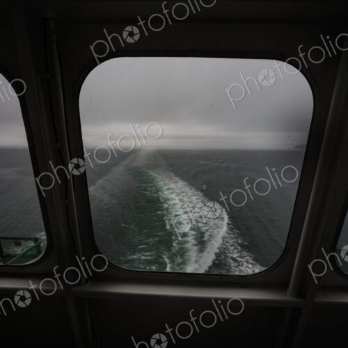 View through a ferry porthole window of the grey stormy weather in the San Juan… View through a ferry porthole window of the grey stormy weather in the San Juan…