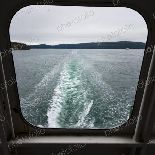 View through a ferry porthole window of the grey stormy weather in the San Juan… View through a ferry porthole window of the grey stormy weather in the San Juan…