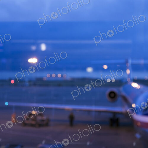 View through an airport window of buildings, of the traffic on the airport runways and… View through an airport window of buildings, of the traffic on the airport runways and…