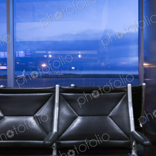 View through an airport window of buildings, of the traffic on the airport runways and… View through an airport window of buildings, of the traffic on the airport runways and…