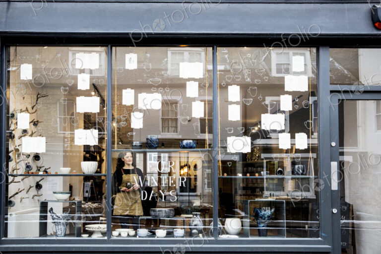 View through window into a pottery shop.