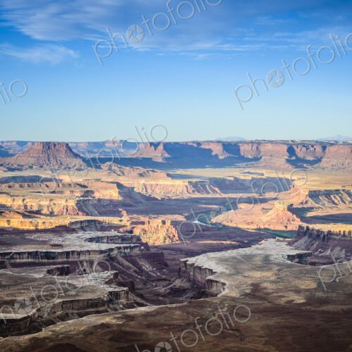 Views across the canyons of the Canyonland National Park at sunset, sandstone ridges…