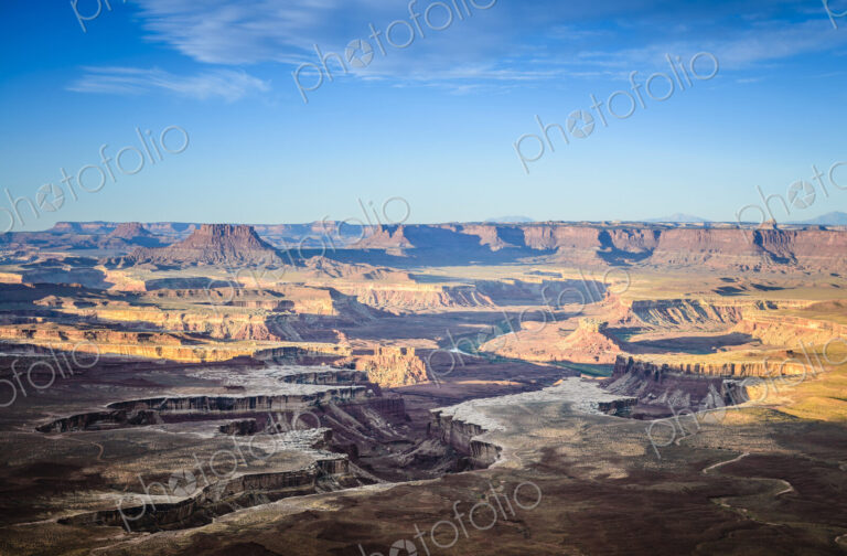 Views across the canyons of the Canyonland National Park at sunset, sandstone ridges…