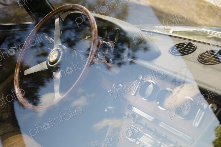 Vintage Ferrari dashboard viewed through window