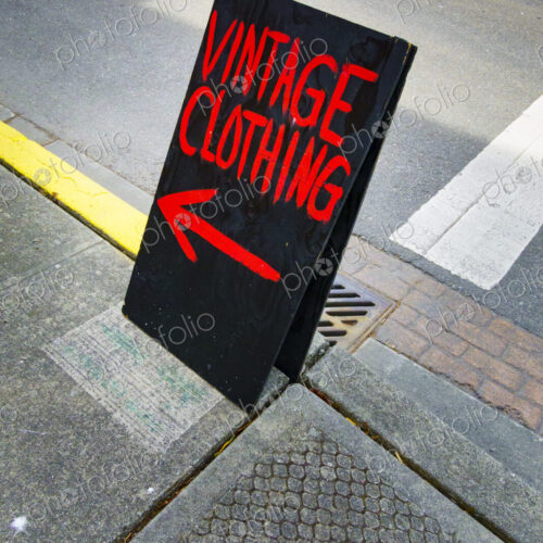 Vintage clothing shop A board sign, a chalk board on a sidewalk with red writing and a… Vintage clothing shop A board sign, a chalk board on a sidewalk with red writing and a…