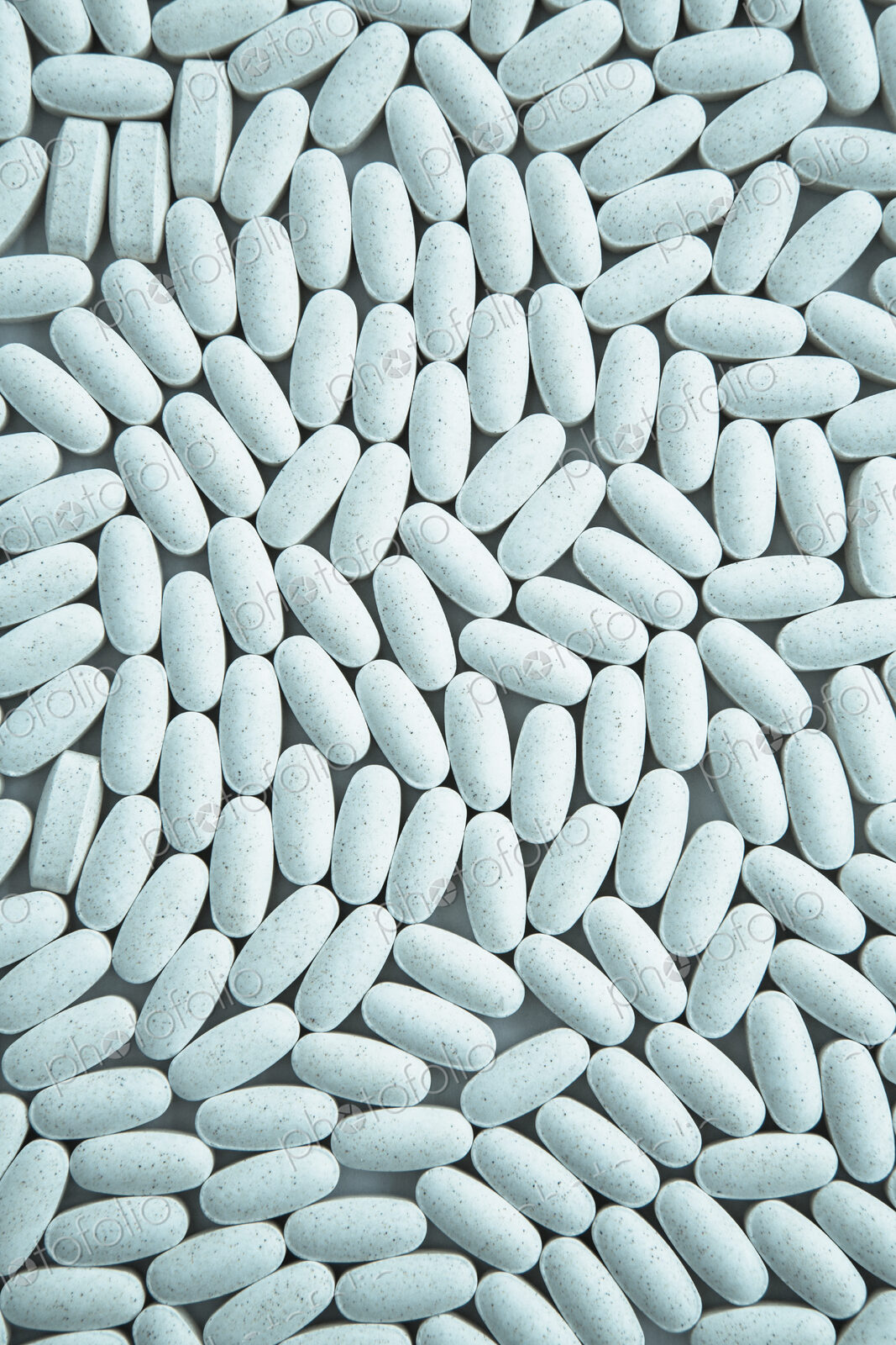 Vitamin C supplements, small blue oval tablets.