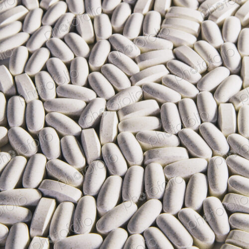 Vitamin C supplements, white oval tablets for consumption. Vitamin C supplements, white oval tablets for consumption.