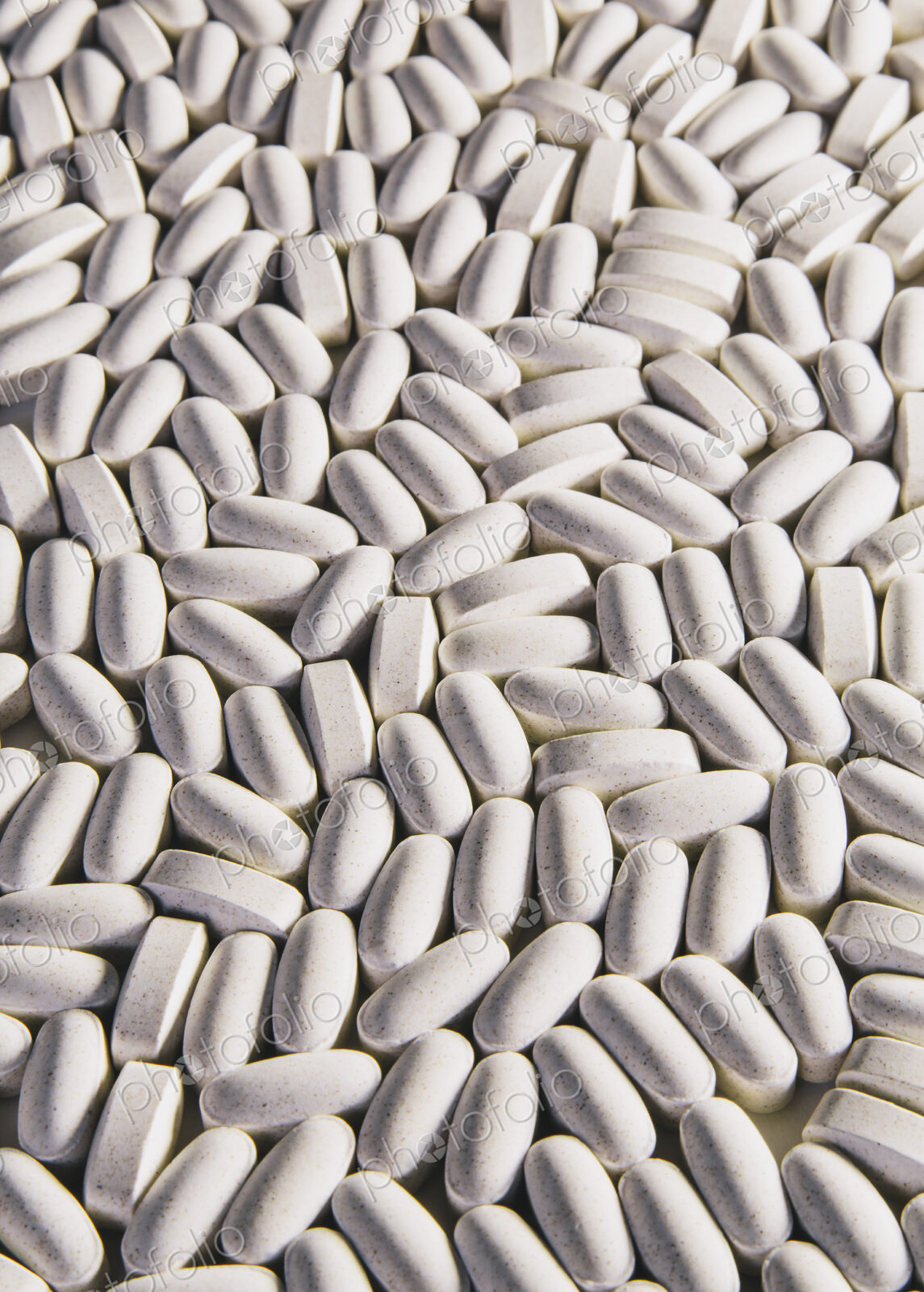 Vitamin C supplements, white oval tablets for consumption.