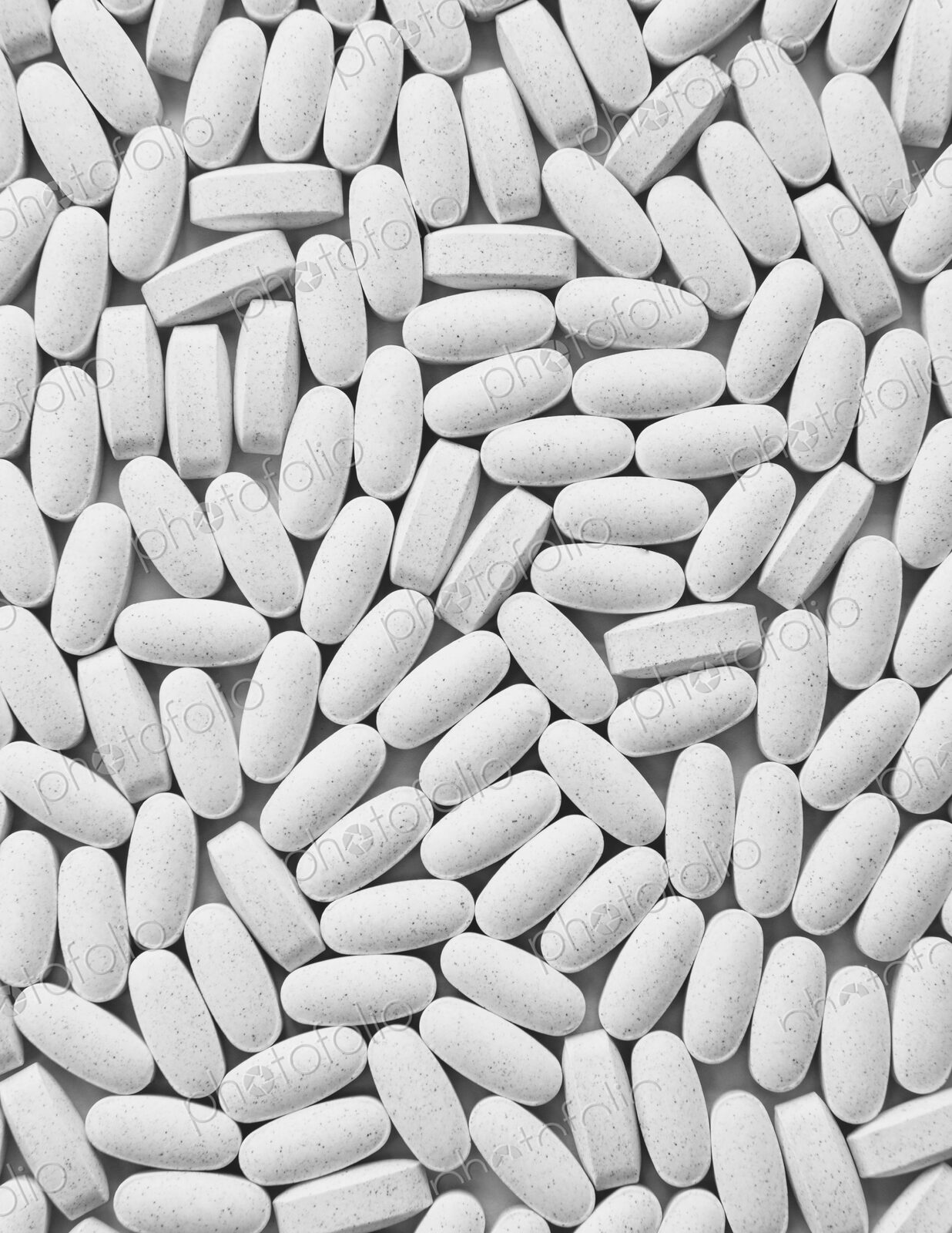 Vitamin C supplements, white oval tablets, taken for health reasons.