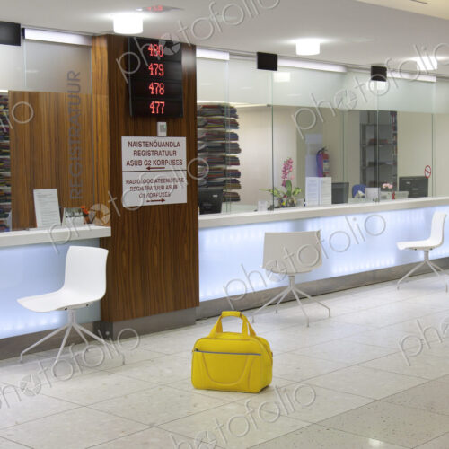 Waiting area and reception desk at a modern hospital, with signs and electronic… Waiting area and reception desk at a modern hospital, with signs and electronic…