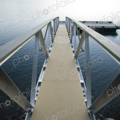 Walkway to jetty in water. Walkway to jetty in water.